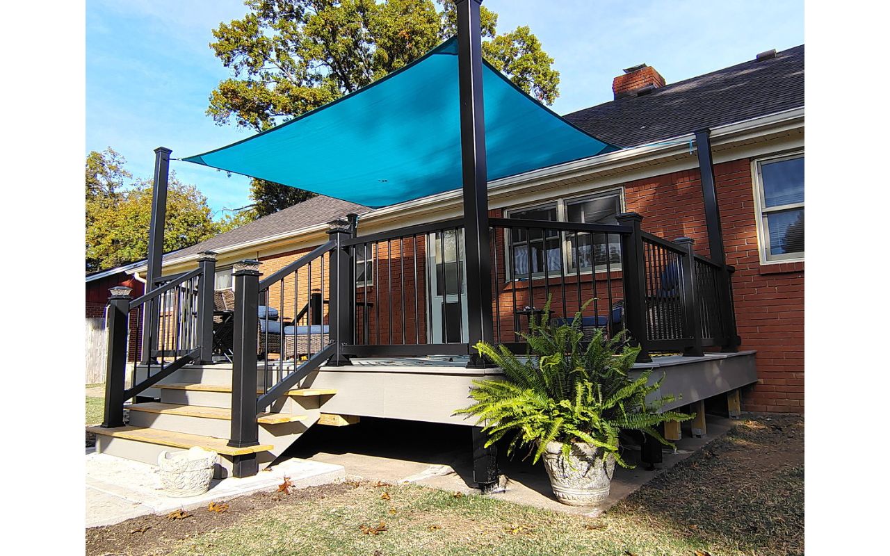 Trex Enhance Basics decking and fascia installation in tide pool color with charcoal black Enhance railing system.
