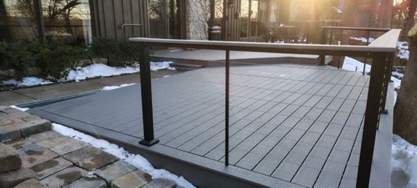 Trex Select Pebble Grey decking installation with black powder coated cable railing.