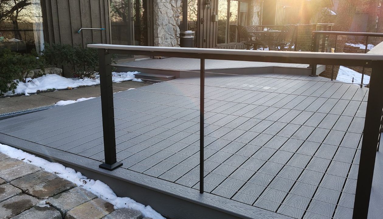Trex Select Pebble Grey decking installation with black powder coated cable railing.