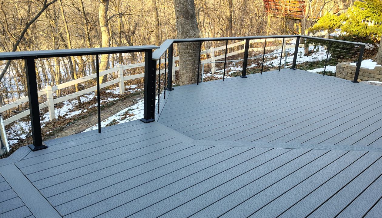 Trex Select Pebble Grey decking installation with black powder coated cable railing.