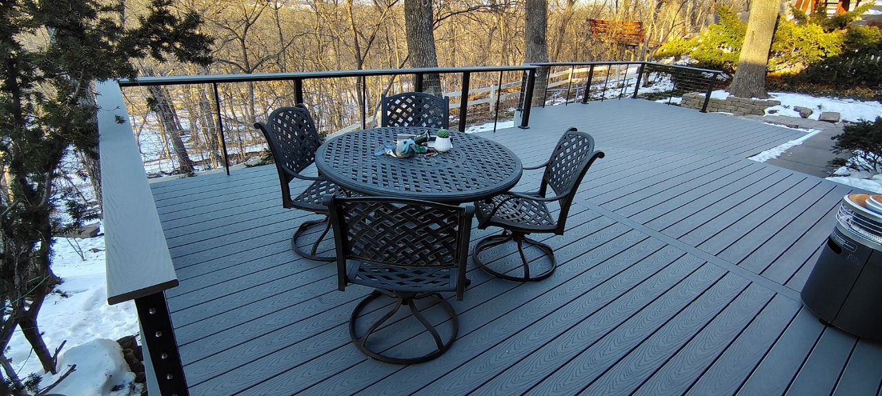 Trex Select Pebble Grey decking installation with black powder coated cable railing.