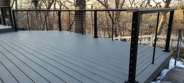 Trex Select Pebble Grey decking installation with black powder coated cable railing.