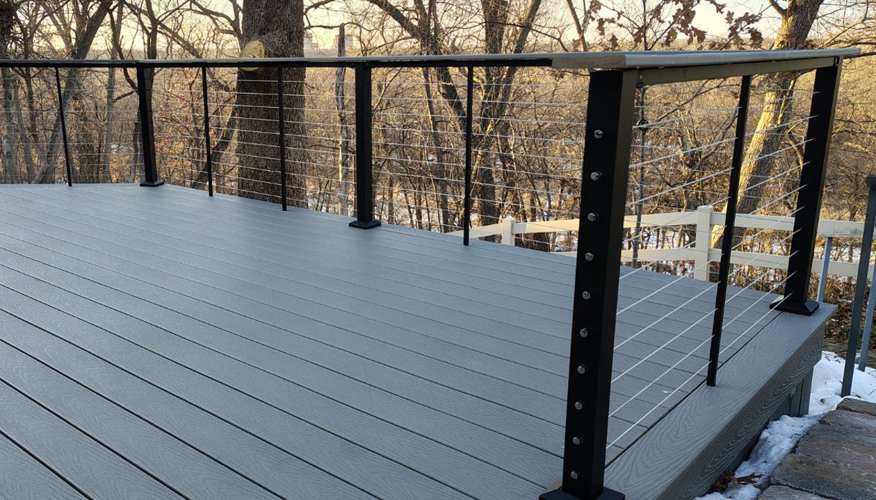 Trex Select Pebble Grey decking installation with black powder coated cable railing.