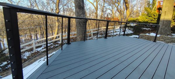 Trex Select Pebble Grey decking installation with black powder coated cable railing.