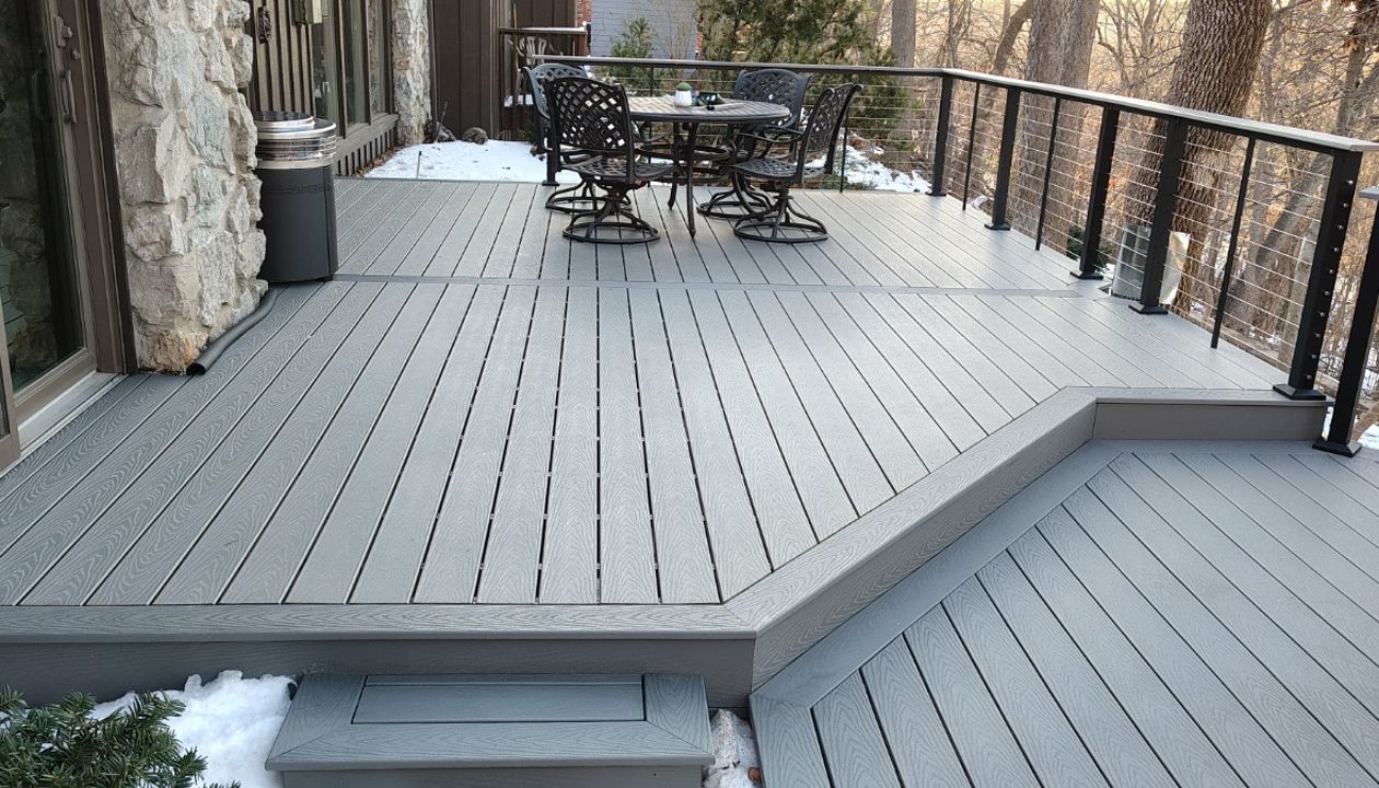 Trex Select Pebble Grey decking installation with black powder coated cable railing.