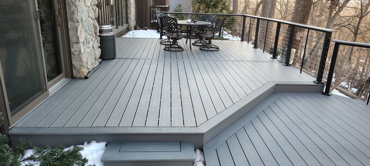 Trex Select Pebble Grey decking installation with black powder coated cable railing.