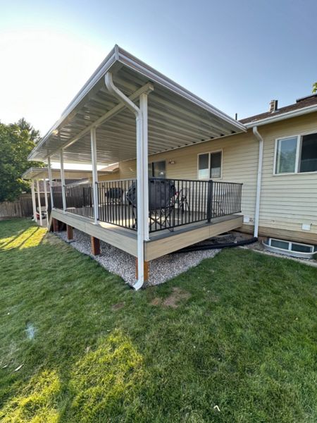A bright and inviting Trex® Honey Grove deck with Trex® Steel Railing, shaded by a custom awning and protected with Trex® Joist Tape — built for comfort, durability, and style.