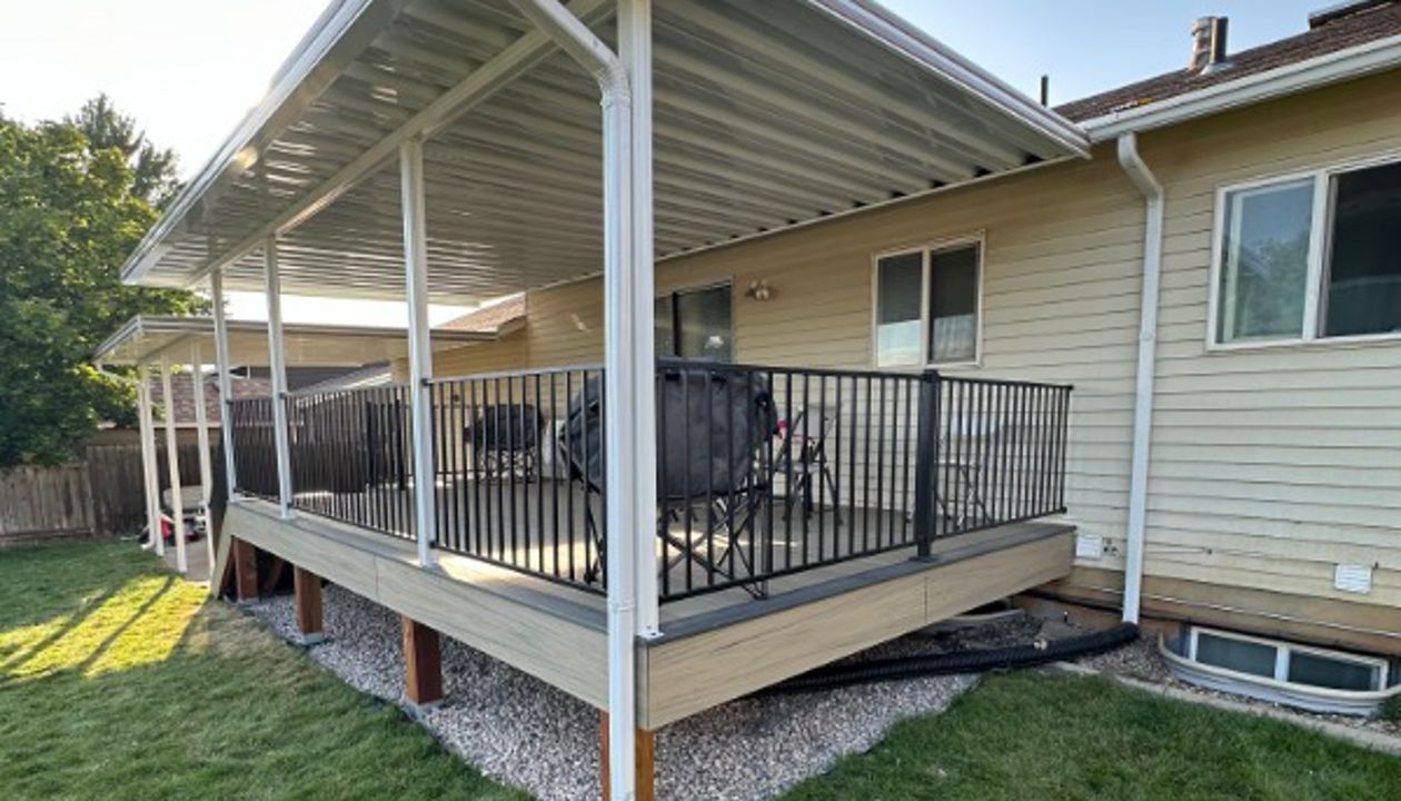 A bright and inviting Trex® Honey Grove deck with Trex® Steel Railing, shaded by a custom awning and protected with Trex® Joist Tape — built for comfort, durability, and style.