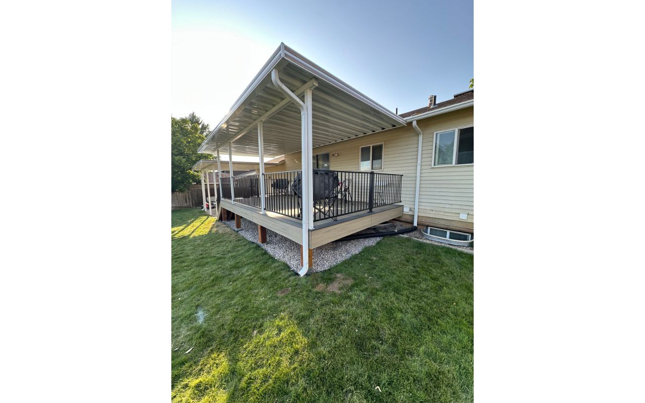 A bright and inviting Trex® Honey Grove deck with Trex® Steel Railing, shaded by a custom awning and protected with Trex® Joist Tape — built for comfort, durability, and style.