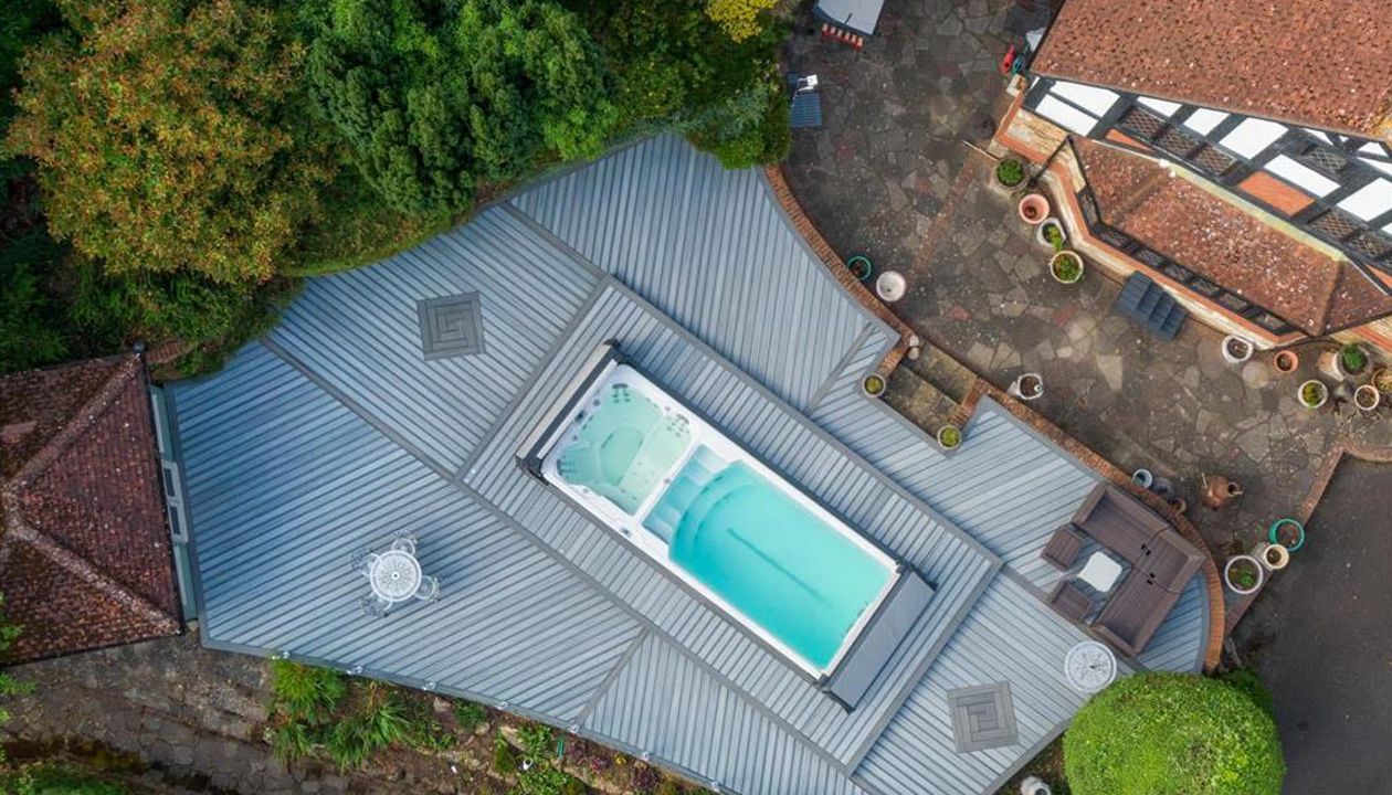 Trex Enhance Naturals Foggy Wharf with Trex Transcend Tropicals Island Mist, Kent. Our brief was to create a large deck to surround the swim spa with access panels for spa maintenance.