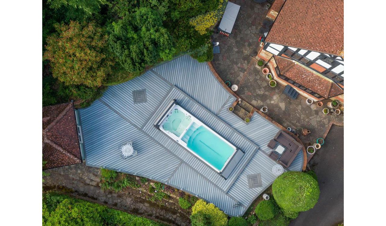 Trex Enhance Naturals Foggy Wharf with Trex Transcend Tropicals Island Mist, Kent. Our brief was to create a large deck to surround the swim spa with access panels for spa maintenance.