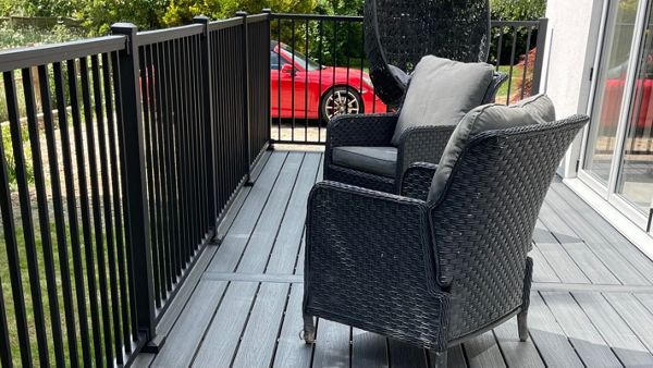 A lovely trex composite deck balcony in calm water from the trex enhanced naturals range with a black powder coated railing system in the trex signature range, located in Pavenham Bedford