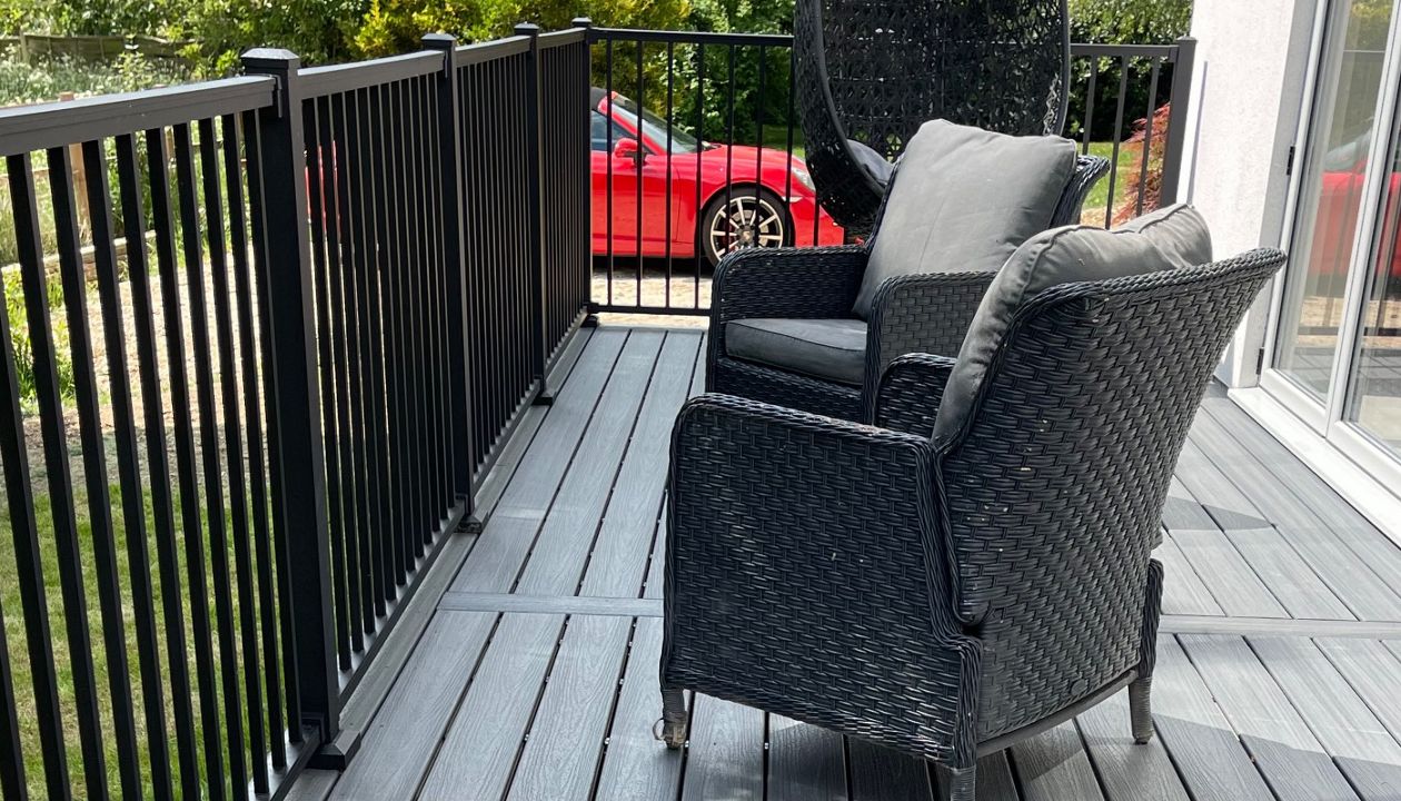 A lovely trex composite deck balcony in calm water from the trex enhanced naturals range with a black powder coated railing system in the trex signature range, located in Pavenham Bedford