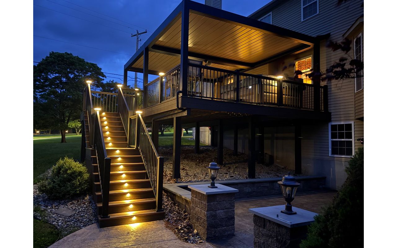 Spiced rum decking with signature aluminum railing and a louvered pergola