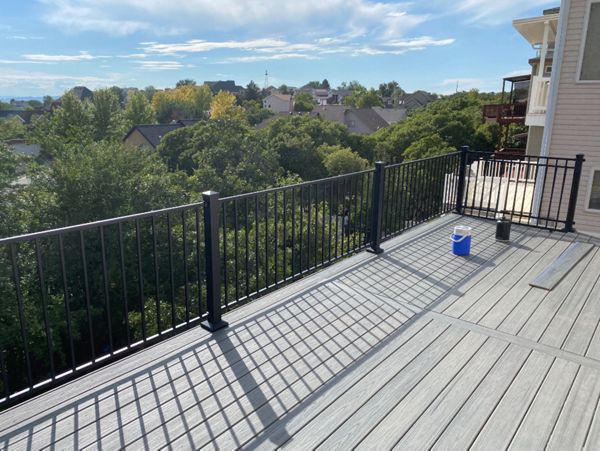 The perfect spot to soak in the view — this Trex® Pebble Grey second-story deck with Trex® Aluminum Railing blends strength, style, and mountain air.