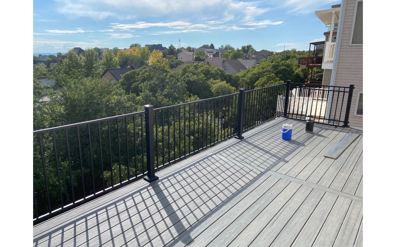 The perfect spot to soak in the view — this Trex® Pebble Grey second-story deck with Trex® Aluminum Railing blends strength, style, and mountain air.