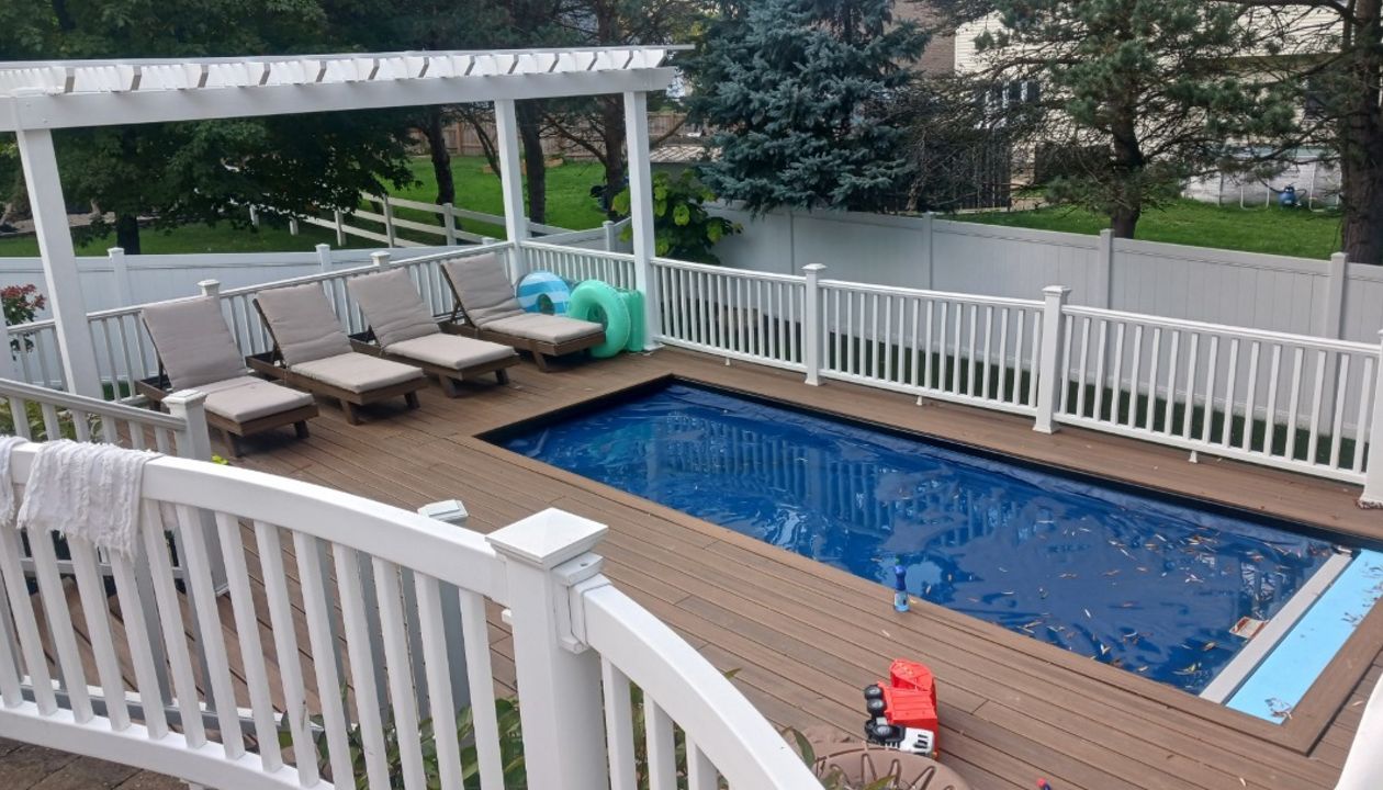 Beautiful, multi-tiered Trex deck with pergola and outdoor dining area.