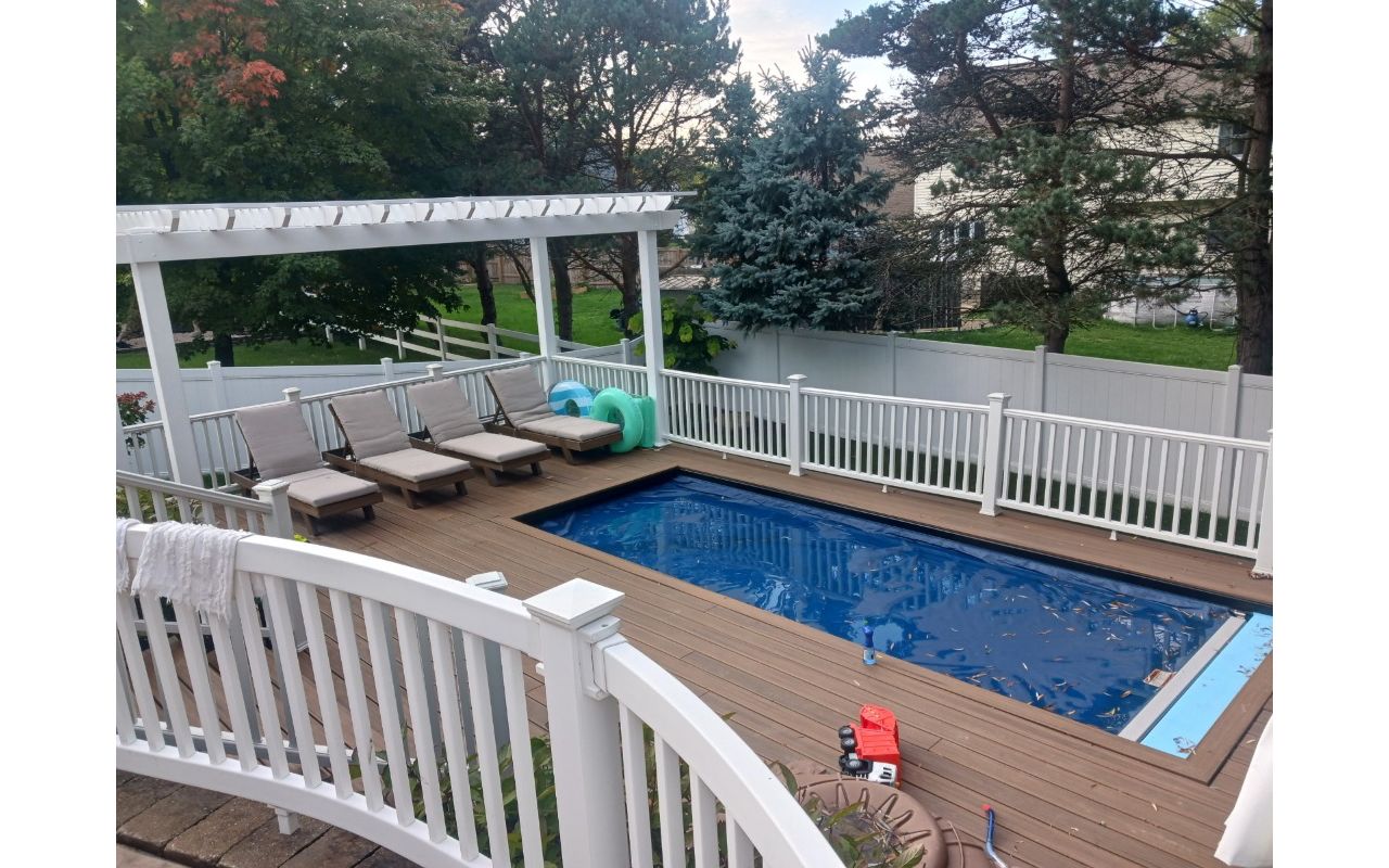 Beautiful, multi-tiered Trex deck with pergola and outdoor dining area.