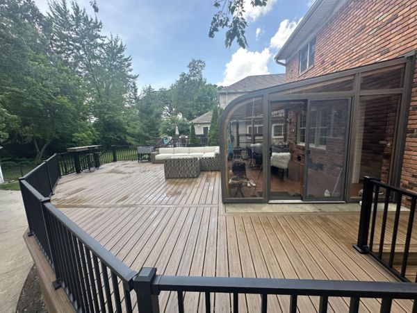 Trex transcend Boards Havana Gold with custom bar and verticle skirting.  Railing: Trex Transcend Signature aluminum railing.