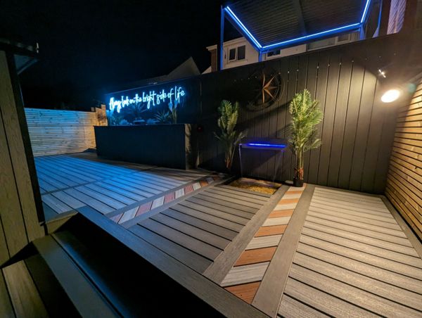 Water feature built into a Trex wall, with a beautiful inlay accenting the area