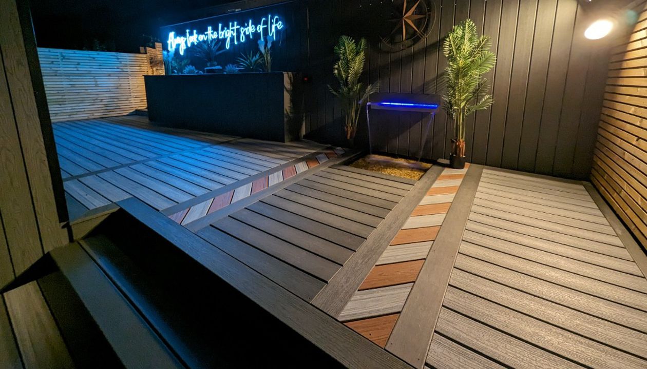 Water feature built into a Trex wall, with a beautiful inlay accenting the area