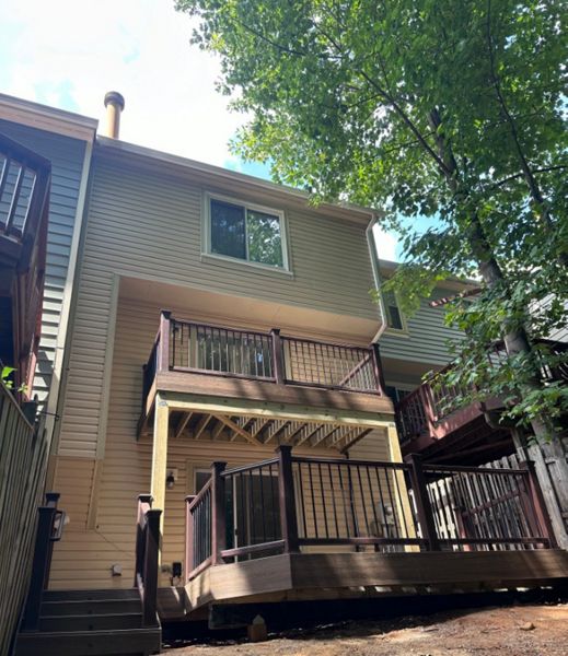 Transcend Vintage Lantern railing. Black round aluminum balusters. TREX Enhance Toasted Sand decking, fascia and step risers