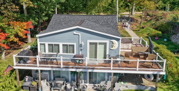 Alton Bay, NH Professional Building Services Wrap Around Deck with Steel Framing and Trex Rain Escapes in Transcend Spiced Rum with Transcend White Railing and Black Metal Balusters