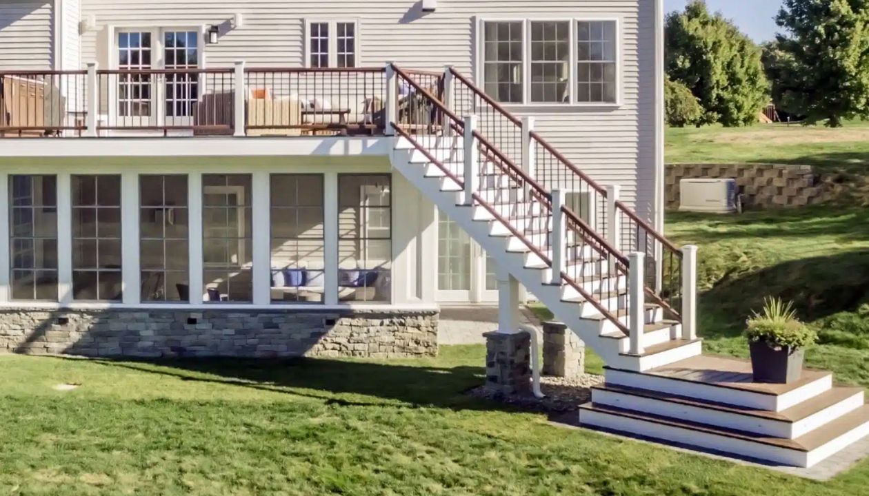 Westford, MA Professional Building Services Design-Build with 4 Season Room, Steel Framing, Cascading Staircase in Transcend Spiced Rum & Vintage Lantern Railing, White Posts, and Black Round Metal Balusters