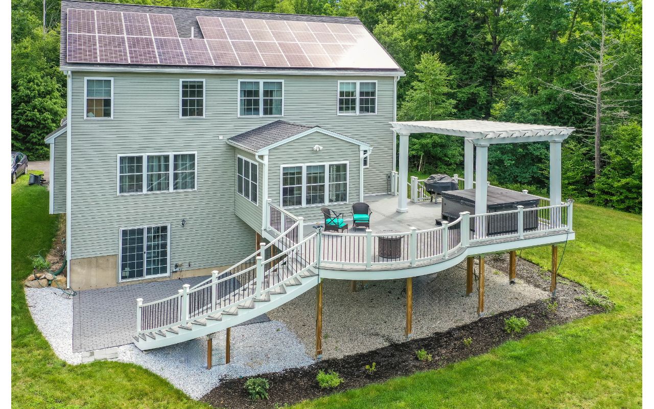 Hopkinton, NH Professional Building Services Mega Curved Deck & Curved Staircase with Steel Framing, Trex Pergola, and Jacuzzi Support