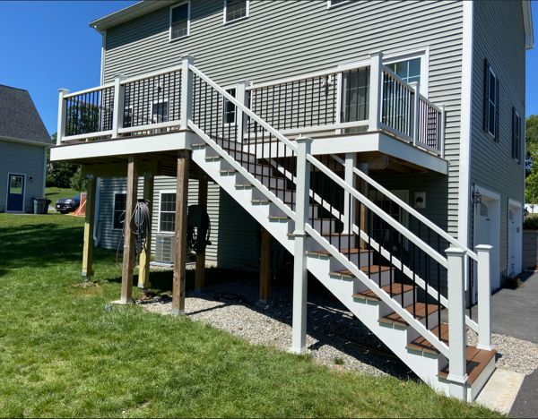 Methuen, MA Professional Building Services 10 x 30 Back Deck in Transcend Spiced Rum with Transcend White Railings and Black Round Metal Balusters