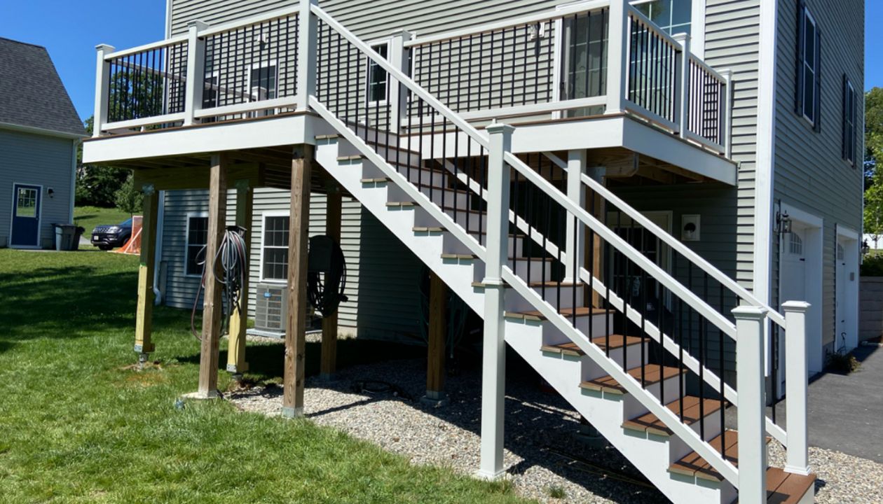 Methuen, MA Professional Building Services 10 x 30 Back Deck in Transcend Spiced Rum with Transcend White Railings and Black Round Metal Balusters