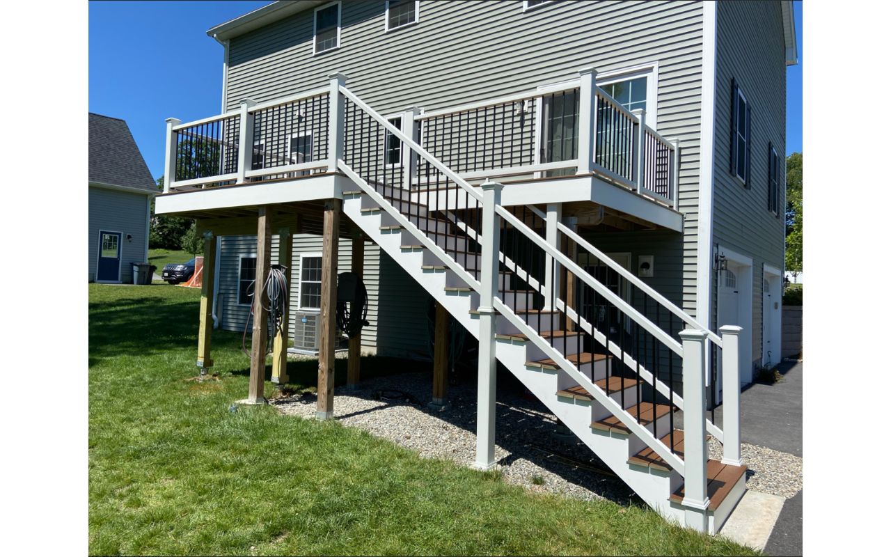 Methuen, MA Professional Building Services 10 x 30 Back Deck in Transcend Spiced Rum with Transcend White Railings and Black Round Metal Balusters