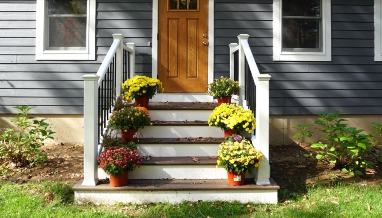 Lee, NH Professional Building Services  Entry Deck in Transcend Spiced Rum with Transcend White Railing & Black Round Metal Balusters