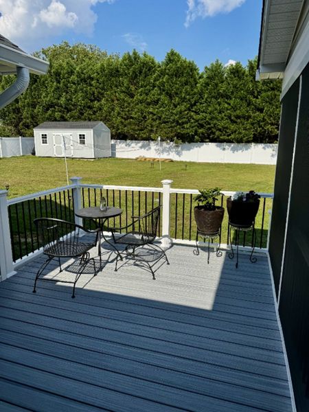 Trex Foggy Wharf composite deck with white vinyl railings and black spindles built in Lillington, NC.