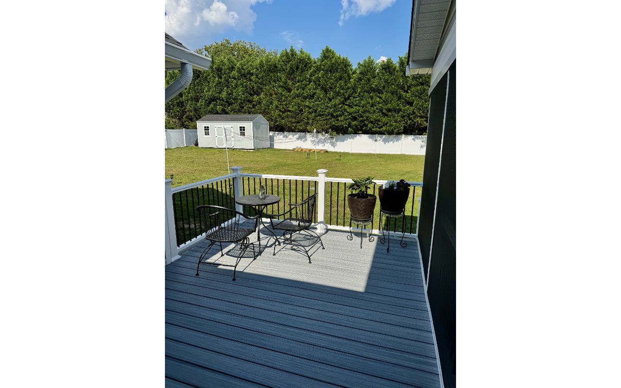 Trex Foggy Wharf composite deck with white vinyl railings and black spindles built in Lillington, NC.