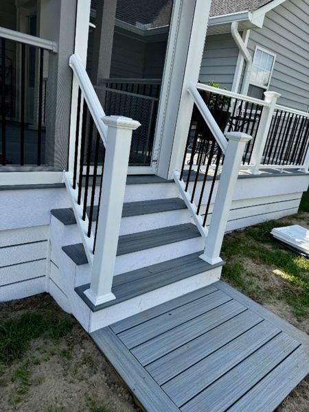 Trex Foggy Wharf composite deck landing and steps featuring crisp white PVC fascia trim. Custom deck builder in Lillington, NC.