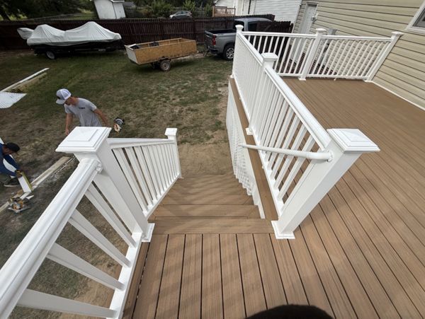 New custom Trex Golden Hour deck featuring white composite railings, color-matched face screws, and a white privacy diamond lattice underpinning. Expert deck construction in Cameron, North Carolina.