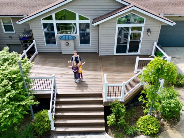 Charming Trex deck with white railings for a welcoming entrance.