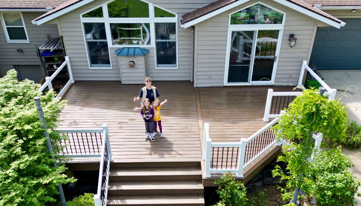 Charming Trex deck with white railings for a welcoming entrance.