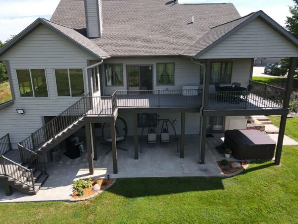 Trex Enhanced Rocky Harbor decking with Coastal Bluff fascia, risers, and post wraps.