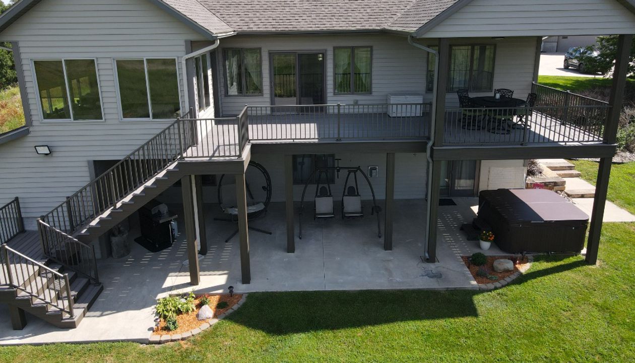 Trex Enhanced Rocky Harbor decking with Coastal Bluff fascia, risers, and post wraps.