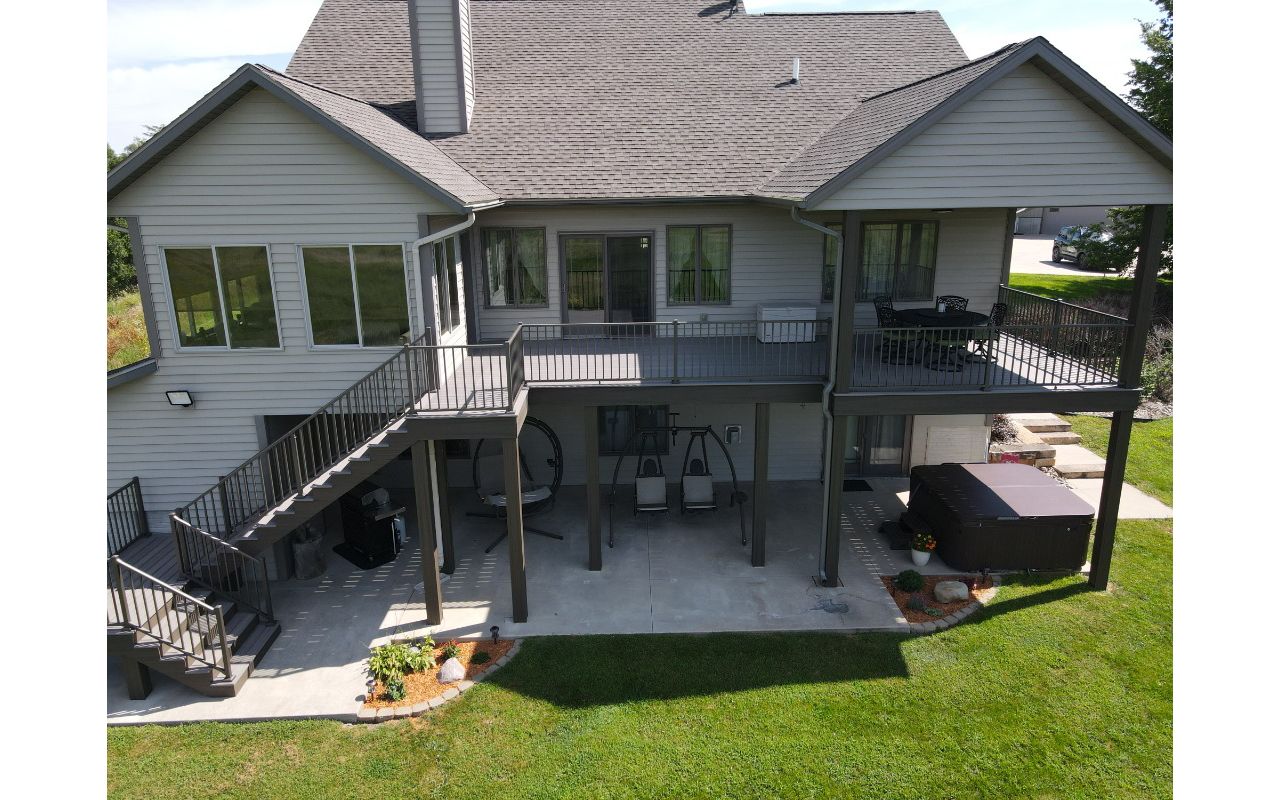 Trex Enhanced Rocky Harbor decking with Coastal Bluff fascia, risers, and post wraps.