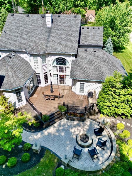 Stylish curved deck overlooking a scenic view with modern furnishings.