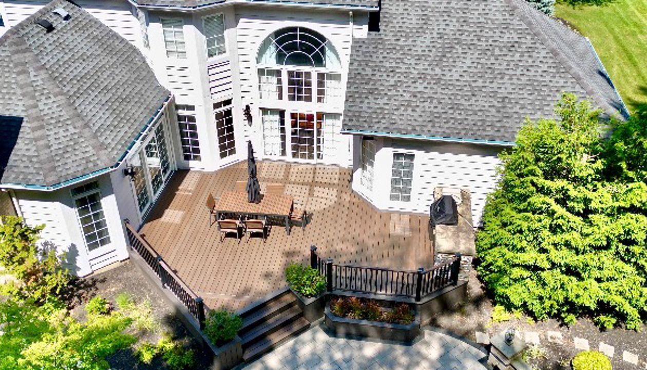 Stylish curved deck overlooking a scenic view with modern furnishings.
