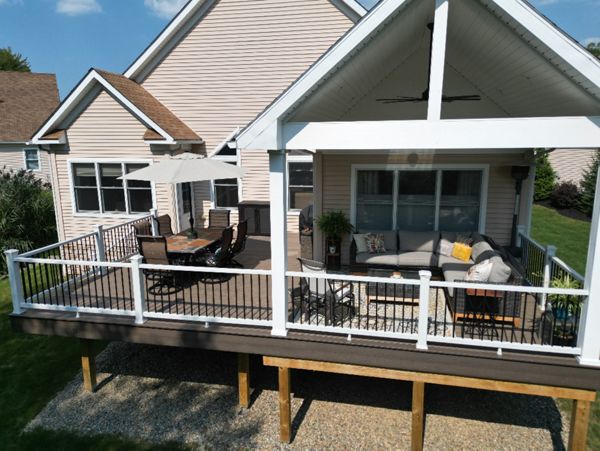 Covered deck area with stylish furnishings and ample outdoor seating.