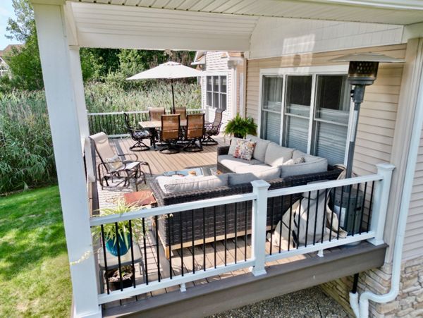 Compact, covered porch deck for a cozy outdoor relaxation spot.