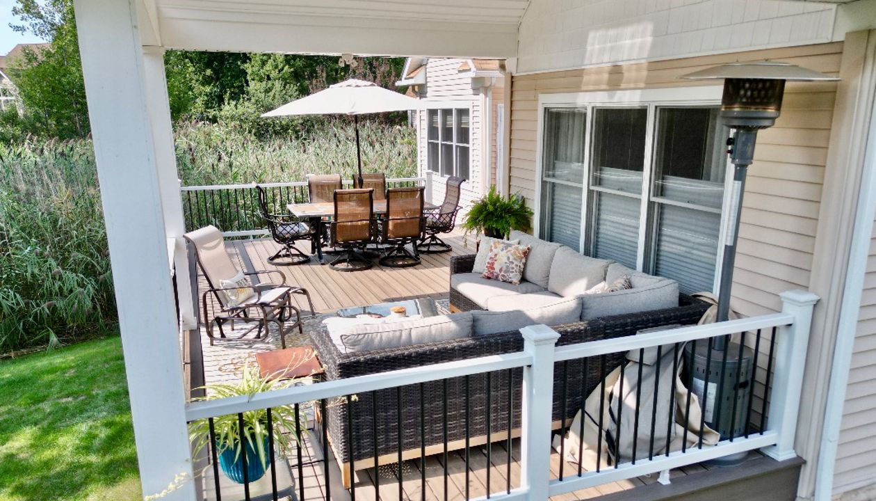 Compact, covered porch deck for a cozy outdoor relaxation spot.
