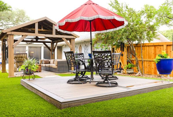 Trex composite deck platform with picture-frame border set into artificial turf
