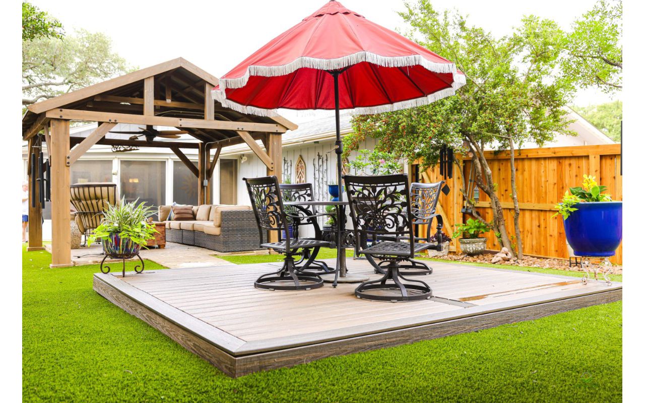 Trex composite deck platform with picture-frame border set into artificial turf