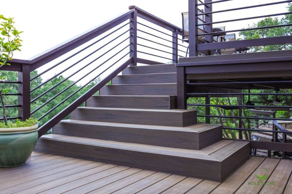 Trex composite stairs with horizontal metal railing leading to a second-story deck